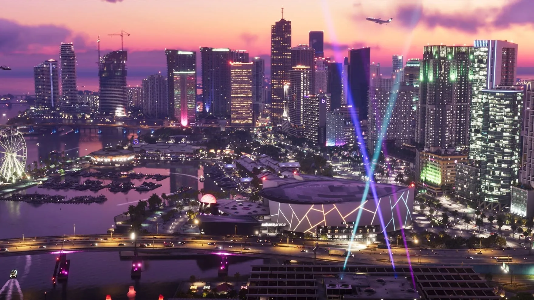 Official GTA VI screenshot: downtown Vice City from above at dusk, with lit skyscrapers, searchlight beams rising from a waterfront arena, a Ferris wheel and a marina full of boats