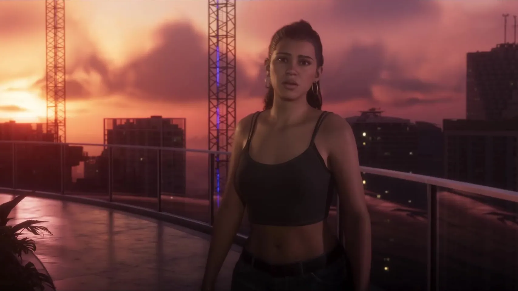 Lucia on a rooftop terrace at sunset with construction cranes and the Vice City towers