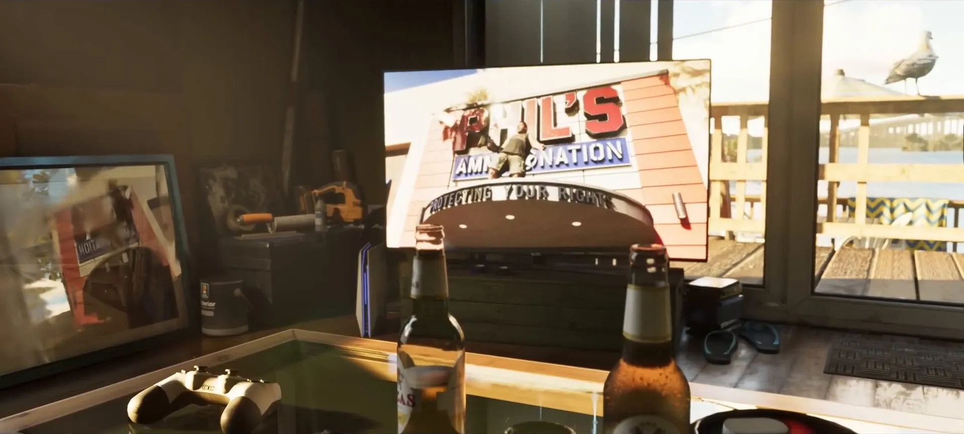 The Phil's Ammu-Nation ad on a television, with the Protecting your rights sign, on a cabinet in a waterfront house with two beers on the table